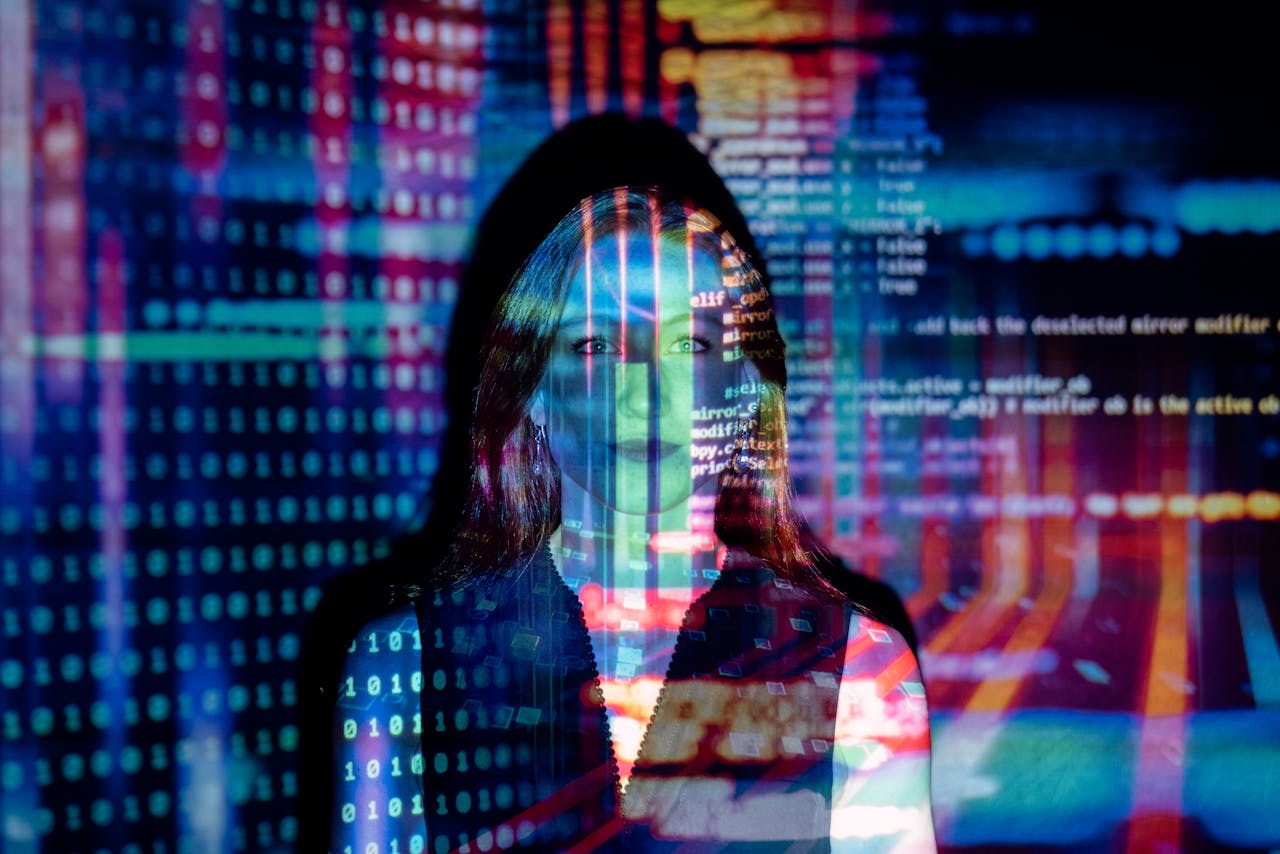 Services-01 A woman with digital code projections on her face, representing technology and future concepts.