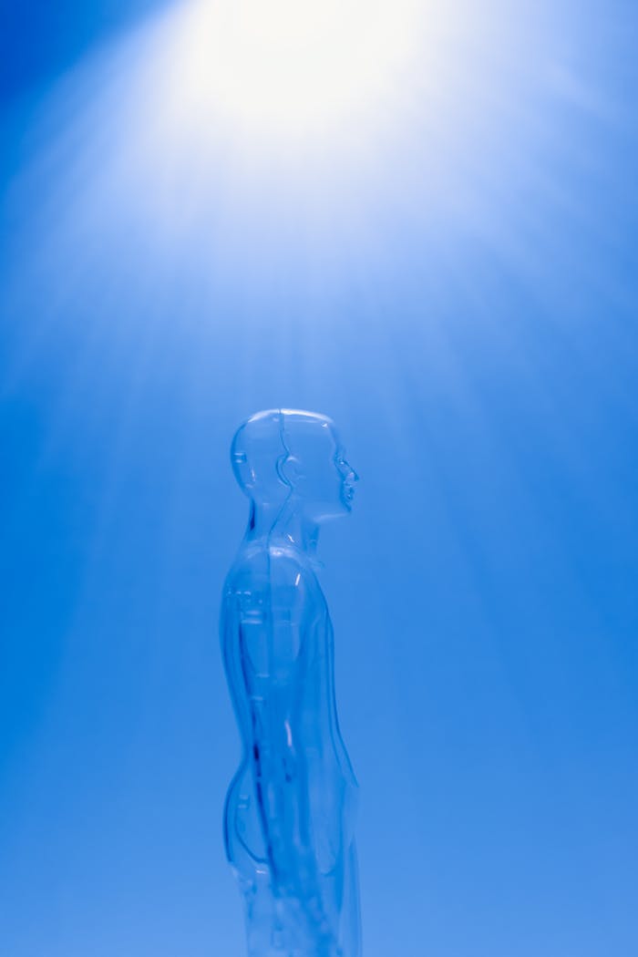 creative-03 A transparent human figure under a bright blue light creating a futuristic ambiance.