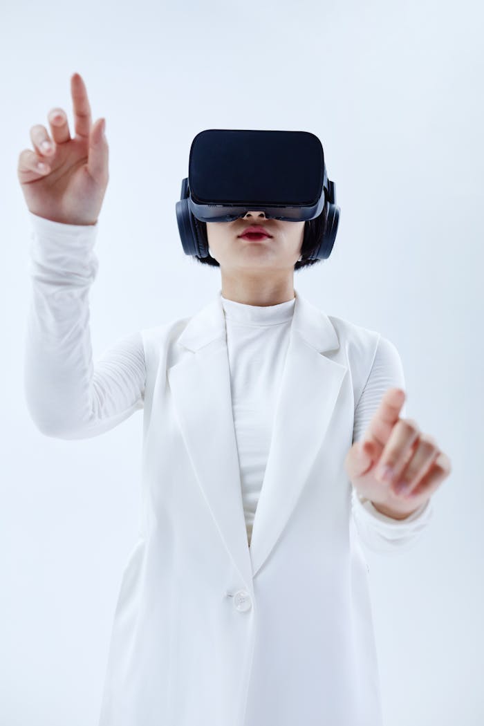 creative Woman using VR headset, exploring technology in a white setting.